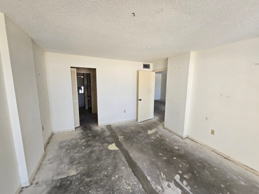 Professional condominium interior demolition project in Siesta Key, Florida, including bathroom demolition, floor removal, common area protection, HVAC removal, and preparation for reconstruction.