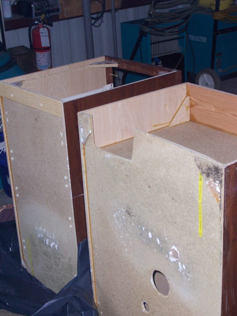 Kitchen cabinets removed for access and mold remediation during successful cabinet salvage project in Sarasota Florida 34232