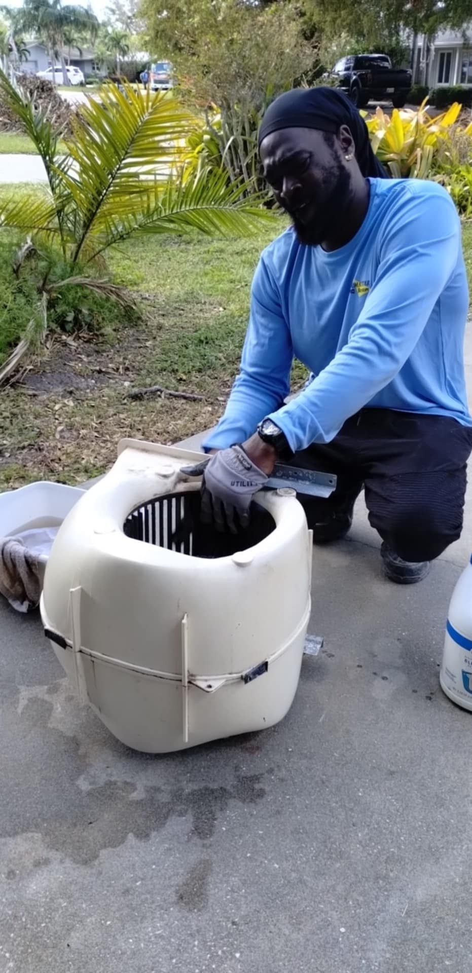 Professional HVAC technician cleaning an air handler blower assembly and duct system during residential HVAC maintenance in Bradenton, Florida.