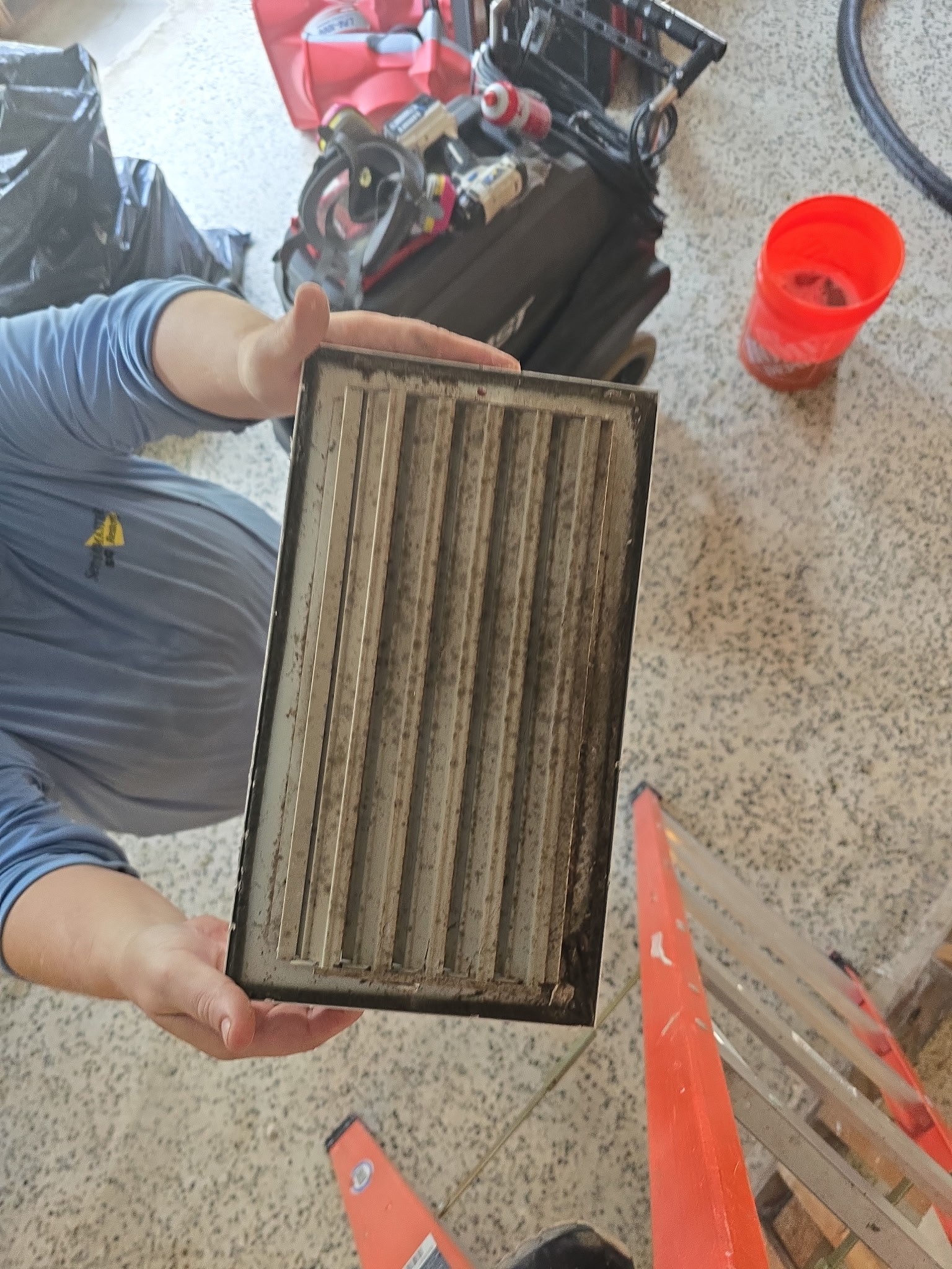 HVAC register with heavy accumulated debris removed for cleaning during a Bradenton mold remediation project.